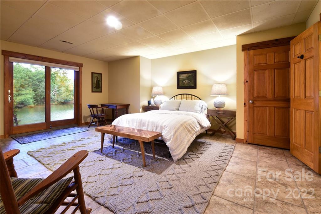 175 Clearview Point Drive Mount Gilead, NC 27306 - Photo 32 of 48 a bedroom with a bed and wooden floor