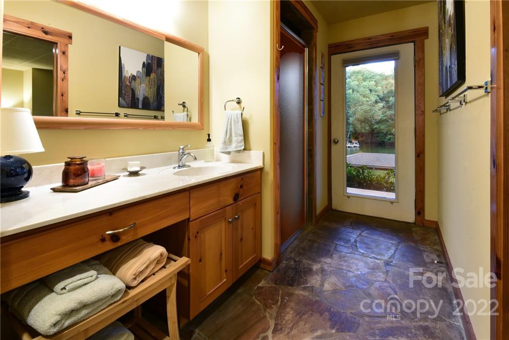 175 Clearview Point Drive Mount Gilead, NC 27306 - Photo 35 of 48 a bathroom with a sink a mirror and next to a window