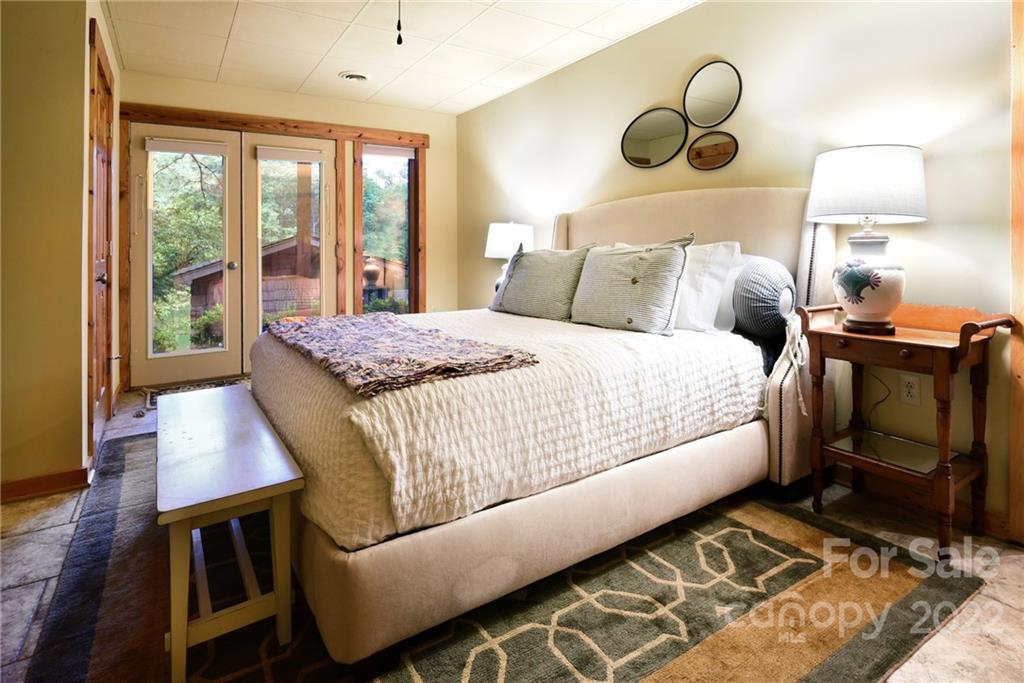 175 Clearview Point Drive Mount Gilead, NC 27306 - Photo 36 of 48 a bedroom with a bed and wooden floor