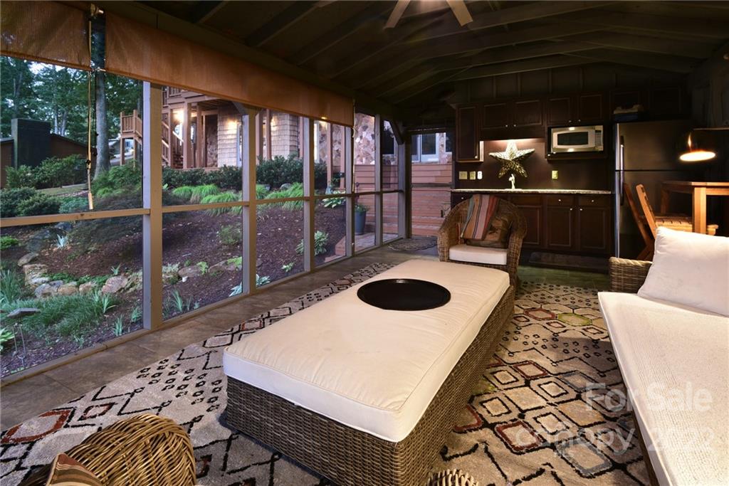 175 Clearview Point Drive Mount Gilead, NC 27306 - Photo 41 of 48 a view of a patio with table and chairs potted plants with floor to ceiling window