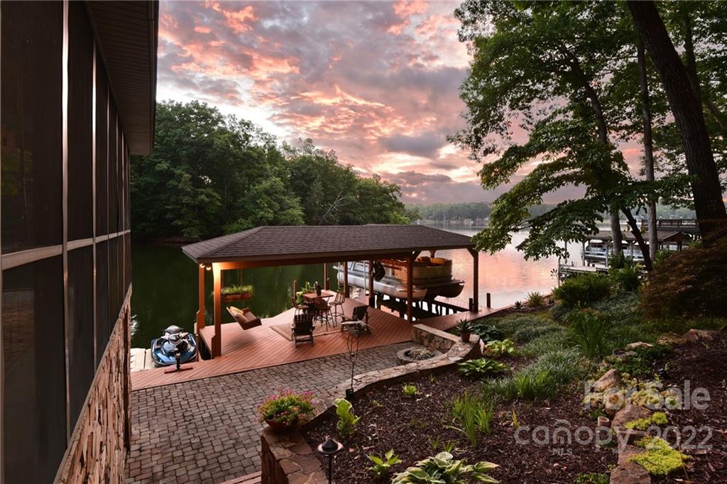 175 Clearview Point Drive Mount Gilead, NC 27306 - Photo 44 of 48 a view of a patio with table and chairs under an umbrella