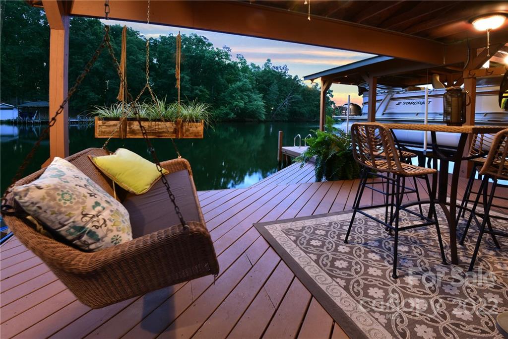 175 Clearview Point Drive Mount Gilead, NC 27306 - Photo 46 of 48 a view of a patio with table and chairs potted plants with wooden floor