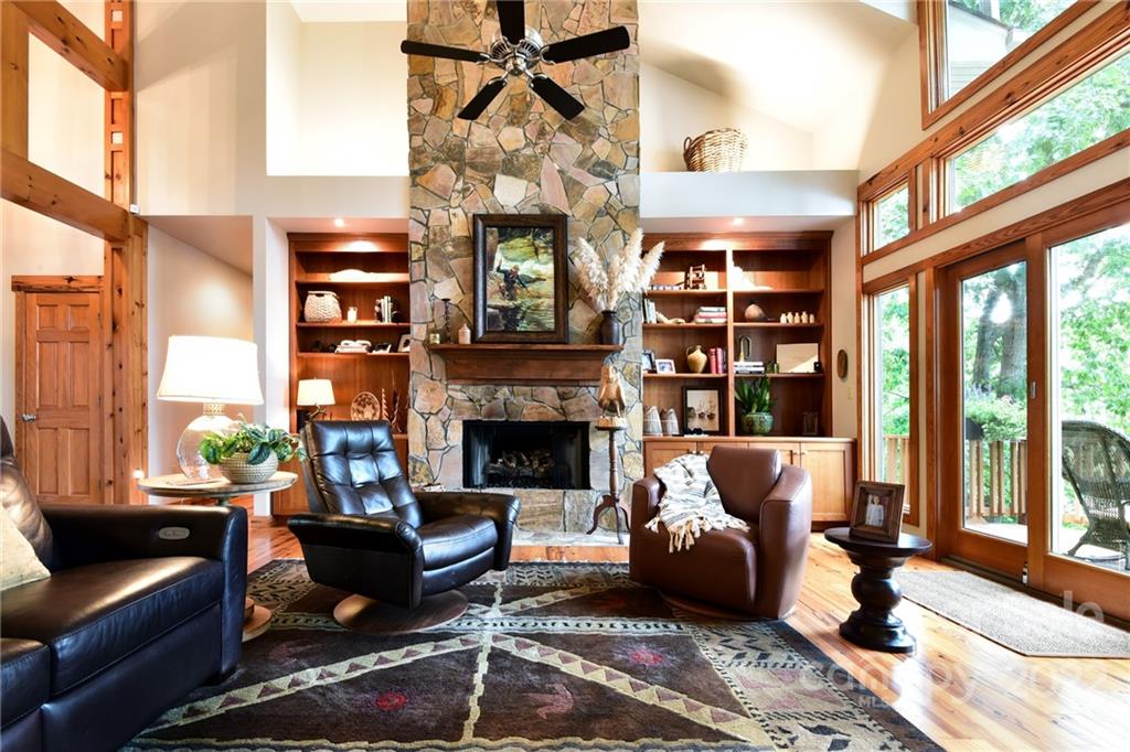 175 Clearview Point Drive Mount Gilead, NC 27306 - Photo 10 of 48 a living room with furniture a fireplace and a large window