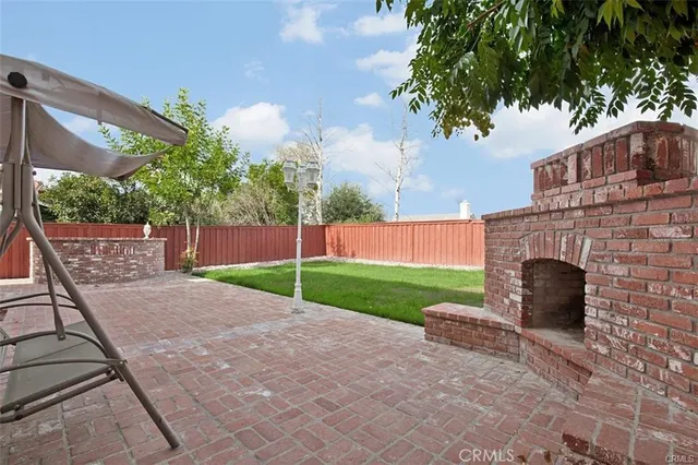 a white house with a yard and a large tree