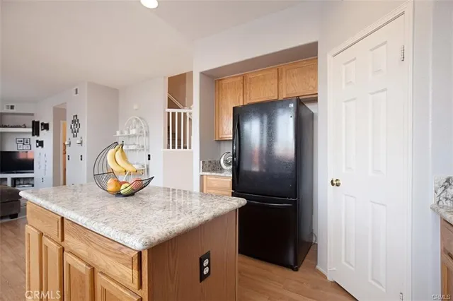 a kitchen with stainless steel appliances granite countertop a refrigerator and a sink