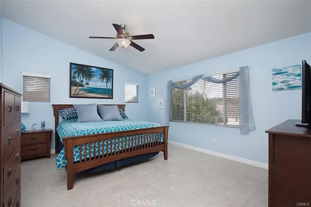 a spacious bedroom with a bed and a window