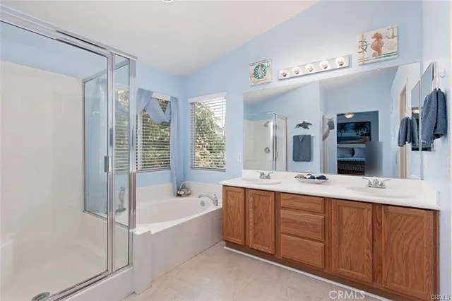 a bathroom with a tub a sink and mirror