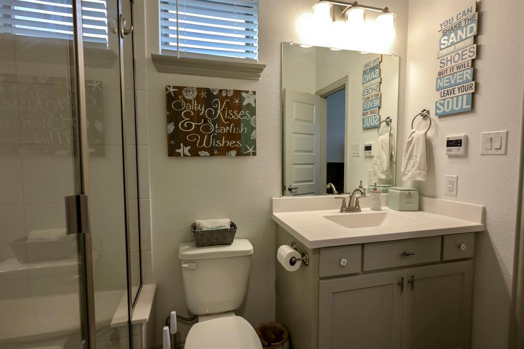 2609 Henley Way Venus, TX 76084 - Photo 11 of 40 a bathroom with a toilet sink and mirror