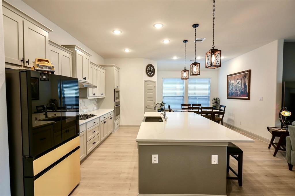 2609 Henley Way Venus, TX 76084 - Photo 12 of 40 a kitchen with kitchen island a sink stainless steel appliances and window