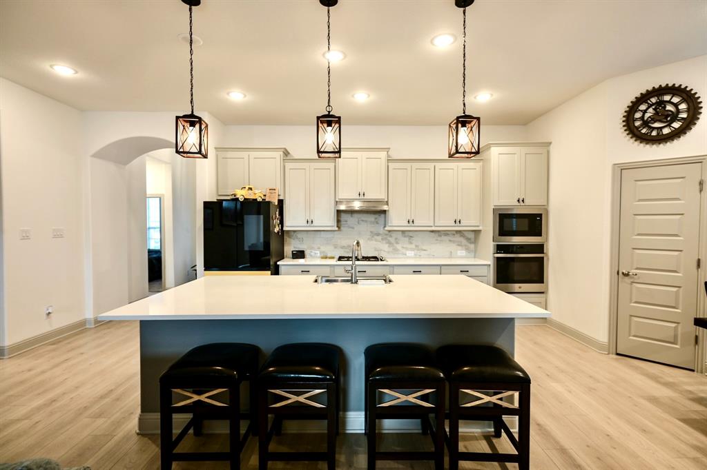 2609 Henley Way Venus, TX 76084 - Photo 14 of 40 a large kitchen with a table and chairs