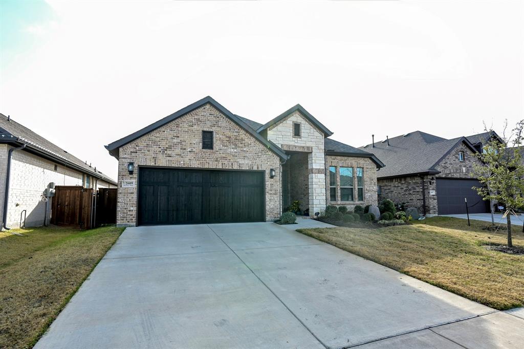 2609 Henley Way Venus, TX 76084 - Photo 2 of 40 a front view of a house with a yard and garage