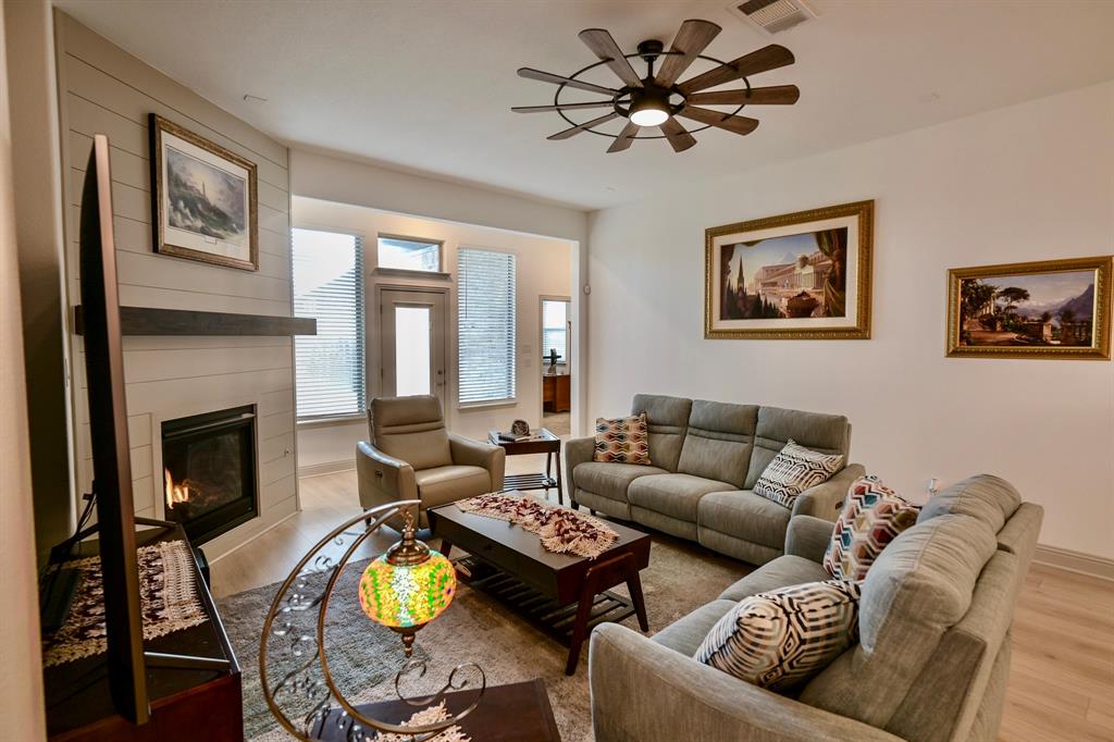 2609 Henley Way Venus, TX 76084 - Photo 20 of 40 a living room with furniture a fireplace and a flat screen tv