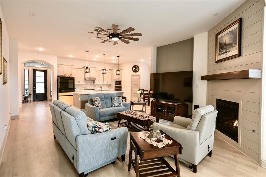 2609 Henley Way Venus, TX 76084 - Photo 23 of 40 a living room with furniture a flat screen tv and a fireplace