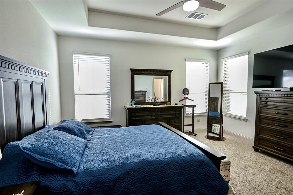 2609 Henley Way Venus, TX 76084 - Photo 27 of 40 a bedroom with a bed and a flat screen tv