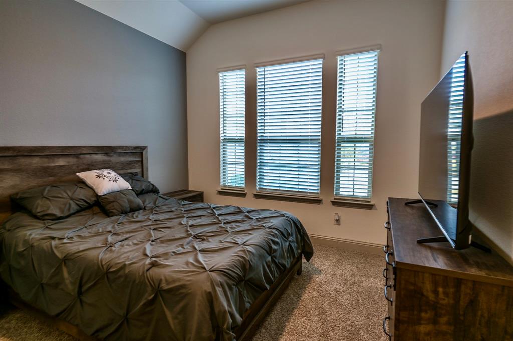 2609 Henley Way Venus, TX 76084 - Photo 8 of 40 a bedroom with a bed a window and potted plant on the dresser