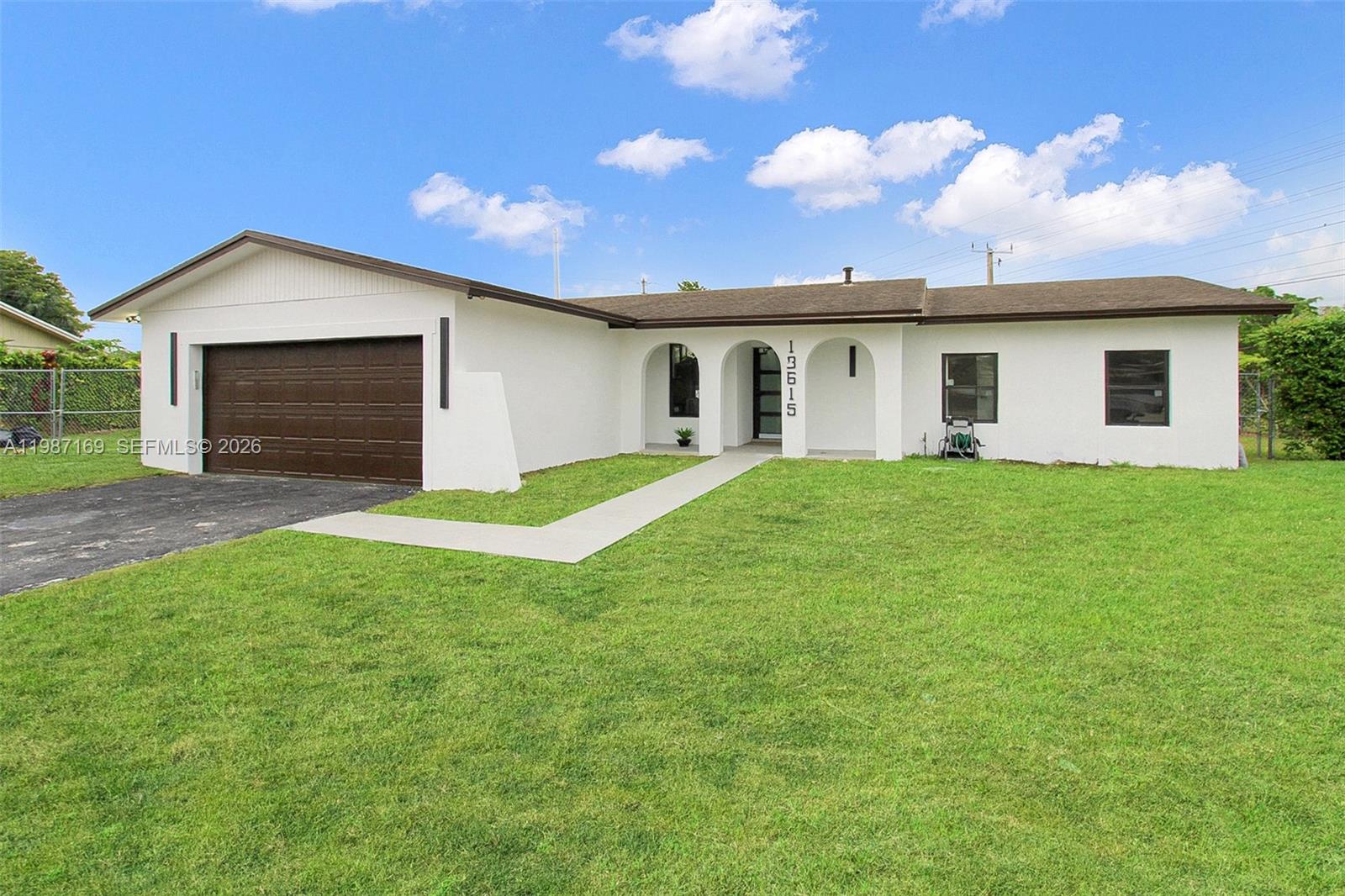 a view of a house with a yard and garage