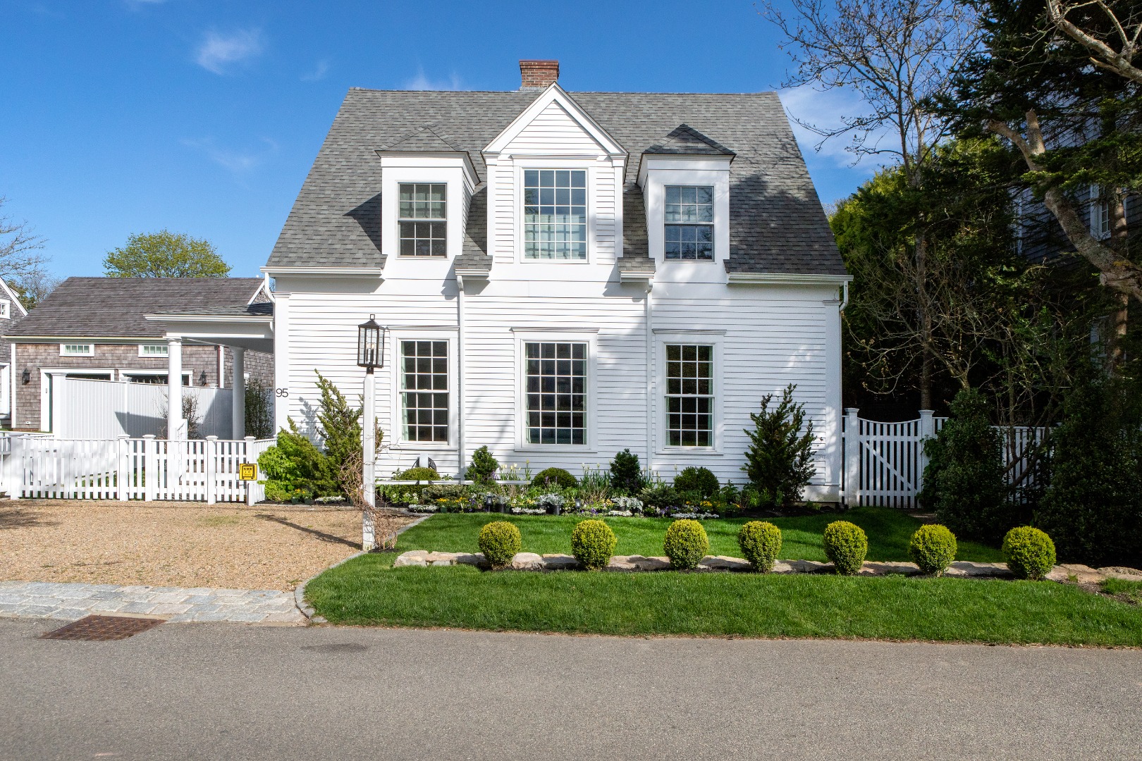 95 School Street Edgartown, MA 02539 - Photo 1 of 57 a front view of a house with a garden