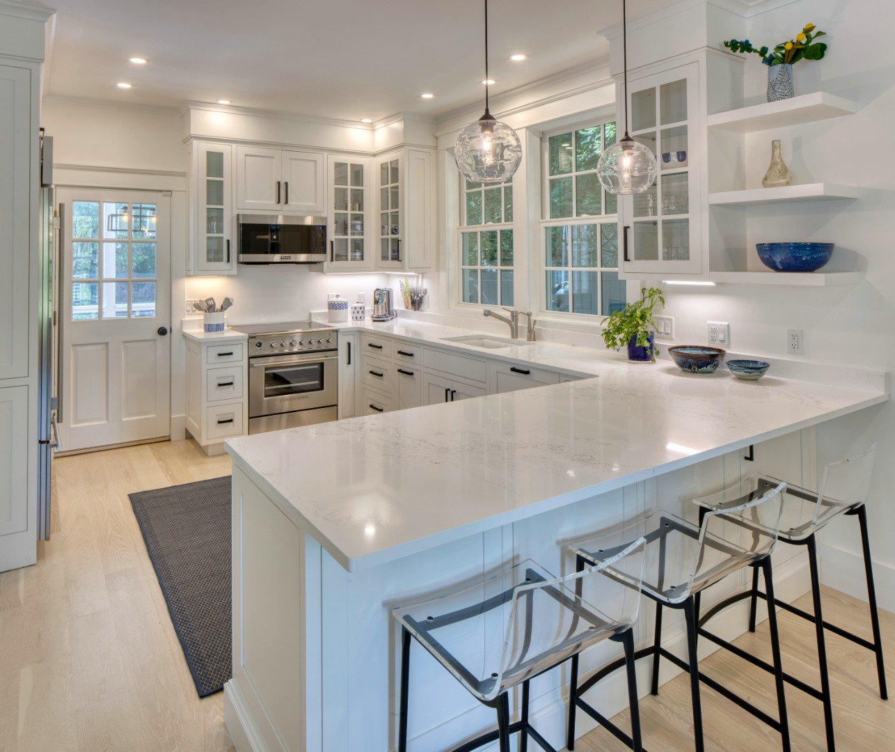95 School Street Edgartown, MA 02539 - Photo 16 of 57 a kitchen with stainless steel appliances granite countertop a stove a sink a oven a dining table and chairs with wooden floor