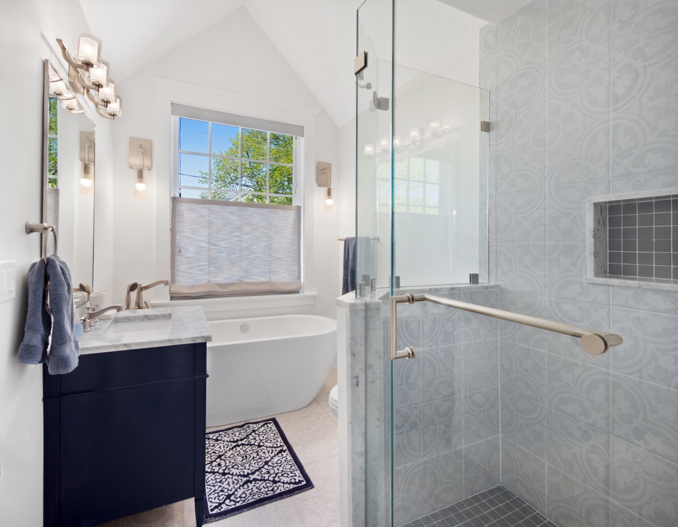 95 School Street Edgartown, MA 02539 - Photo 30 of 57 a bathroom with a double vanity sink toilet mirror and bathtub