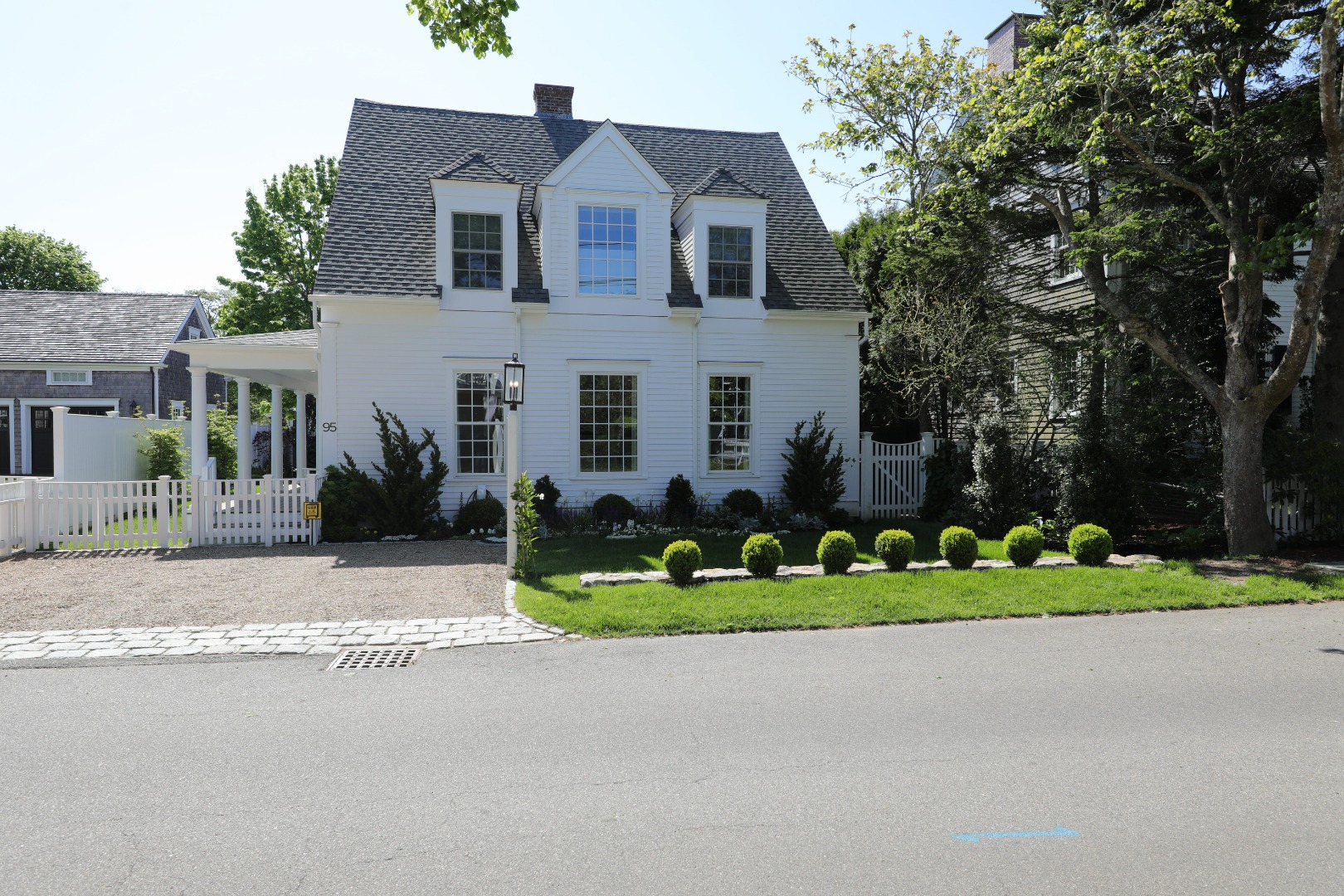95 School Street Edgartown, MA 02539 - Photo 3 of 57 a front view of a house with a yard and potted plants