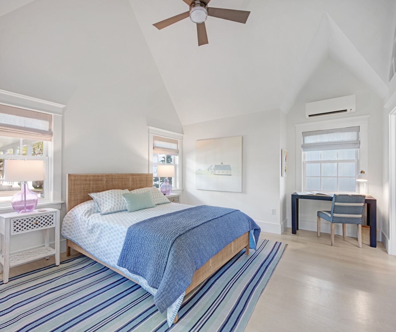 95 School Street Edgartown, MA 02539 - Photo 38 of 57 a bedroom with a bed and a chandelier