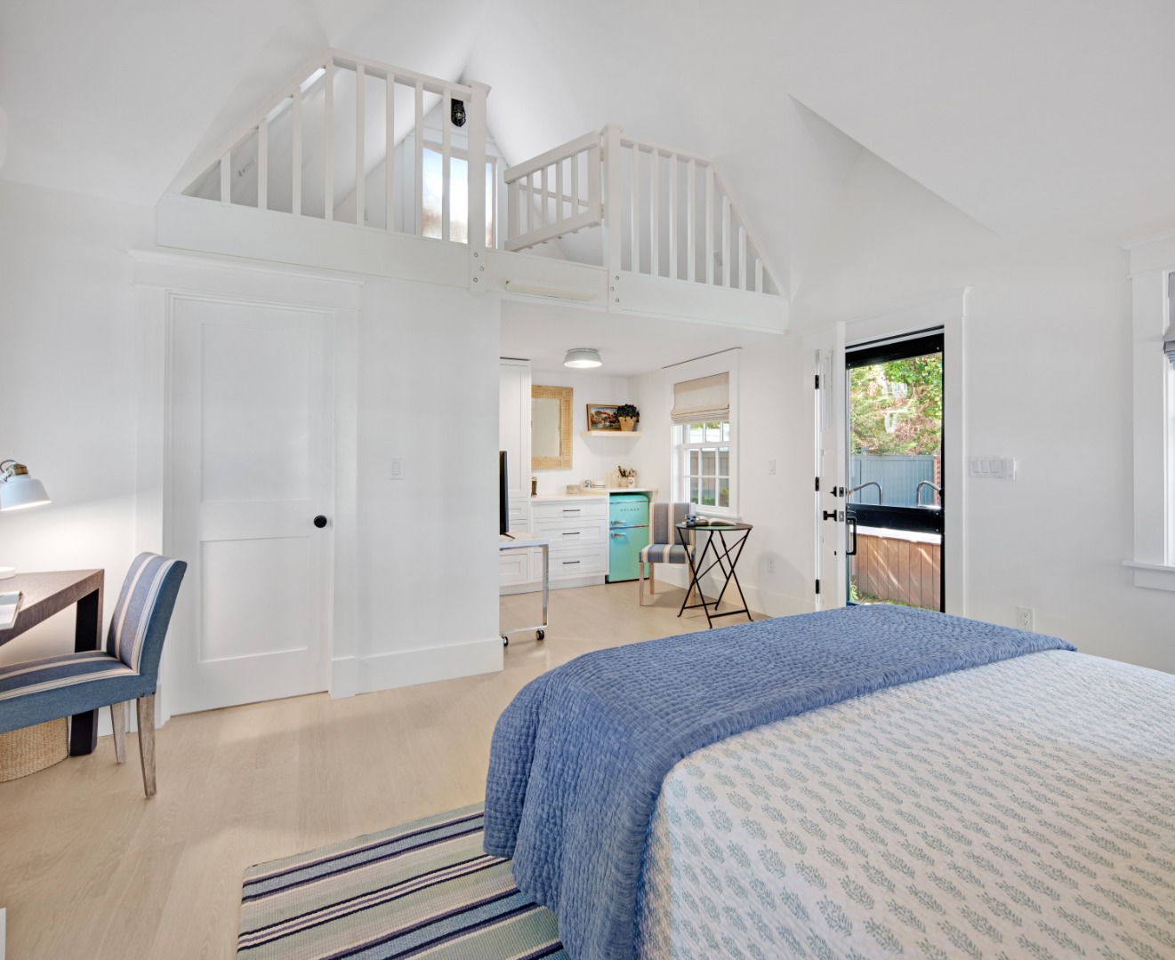 95 School Street Edgartown, MA 02539 - Photo 39 of 57 a spacious bedroom with a bed a chandelier and dresser