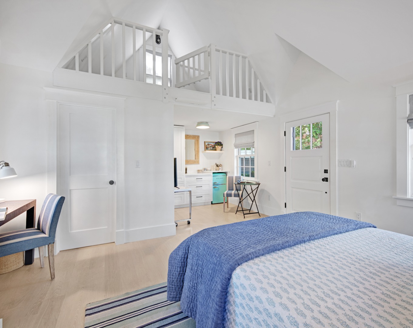 95 School Street Edgartown, MA 02539 - Photo 40 of 57 a bedroom with a bed and a chair