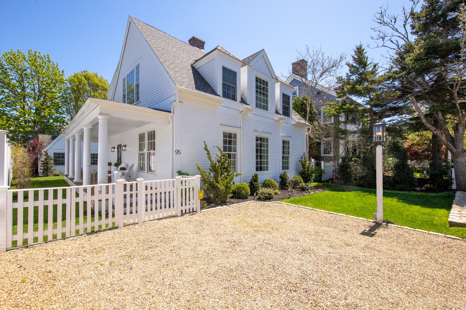 95 School Street Edgartown, MA 02539 - Photo 4 of 57 a view of a white house with a small yard and plants
