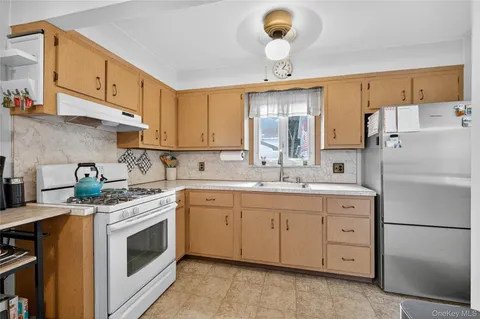 a kitchen with a stove sink and refrigerator