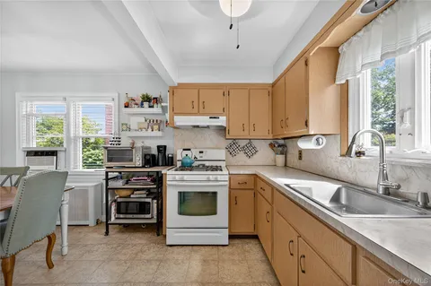 a kitchen with stainless steel appliances a stove sink and cabinets