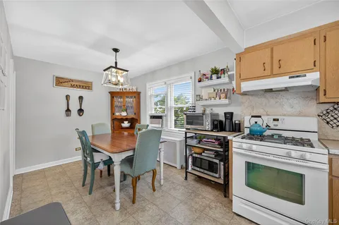 a kitchen with stainless steel appliances granite countertop a stove and cabinets