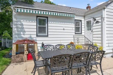a view of a house with a backyard and a patio