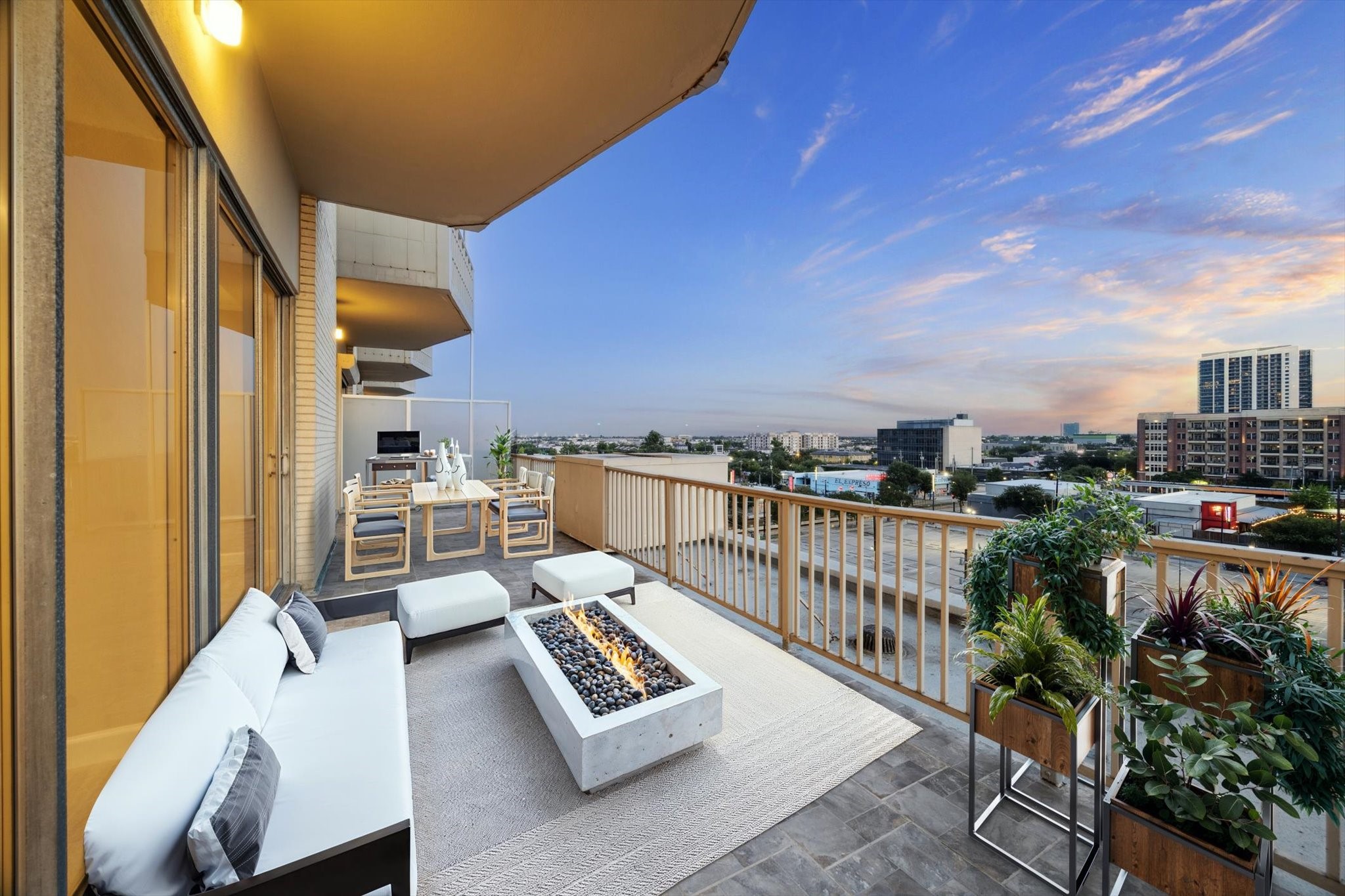 a balcony with city view and wooden floor