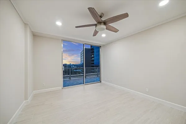 an empty room with closet and fan