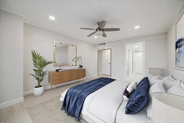 a bedroom with a bed and a chandelier