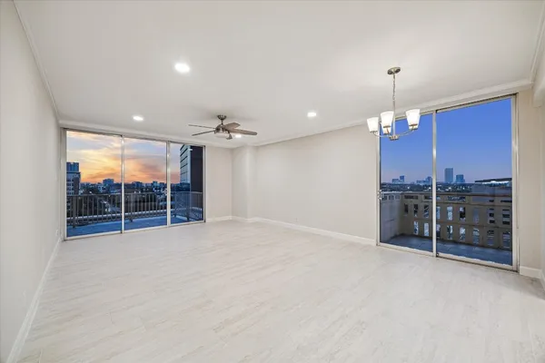 an empty room with furniture and a chandelier
