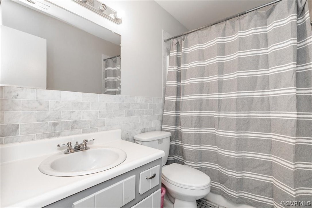 8401 Boones Trail Road Chesterfield, VA 23832 - Photo 7 of 24 a bathroom with a sink a toilet and a mirror