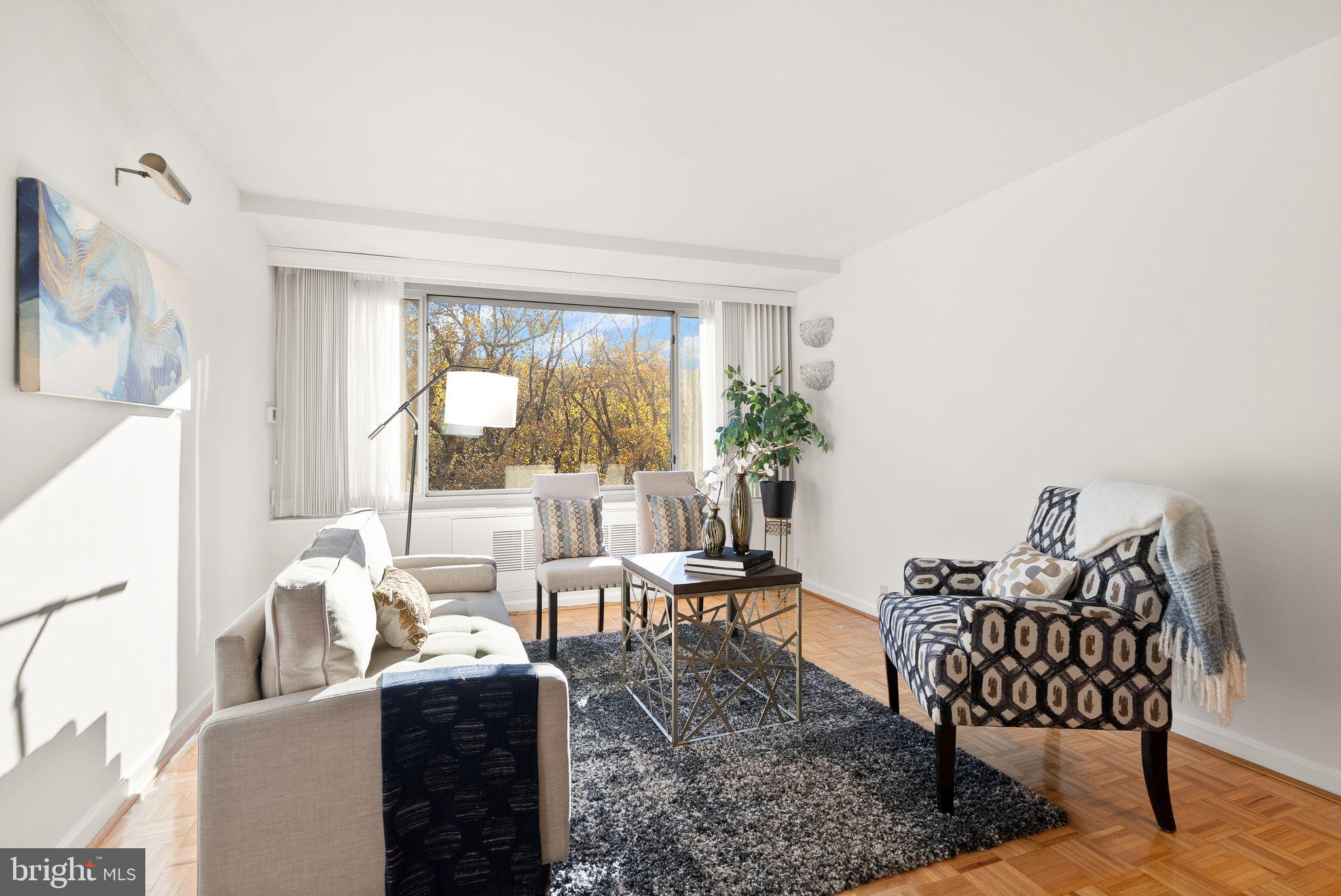 4200 Cathedral Avenue Northwest, Unit 812 Washington, DC 20016 - Photo 2 of 45 a living room with furniture and a large window