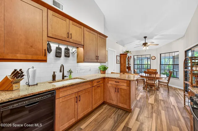 a kitchen with sink cabinets and wooden floor