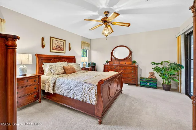 a bedroom with a bed mirror and a large window