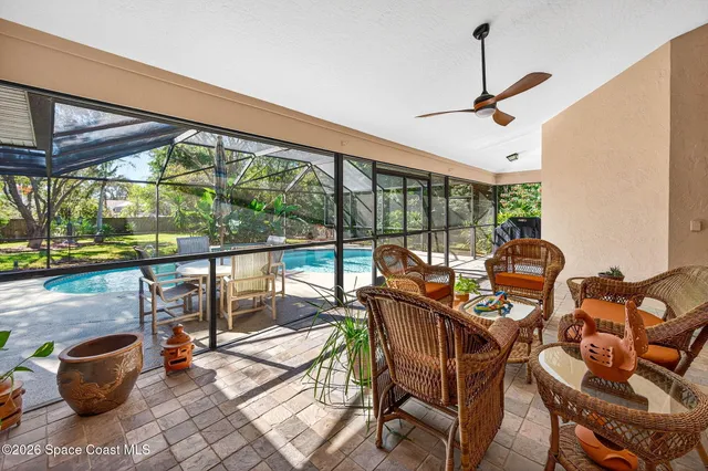 a dining room with furniture water view and a floor to ceiling window