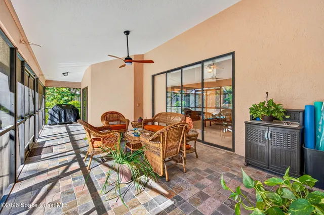 a view of a patio with table and chairs potted plants with wooden floor