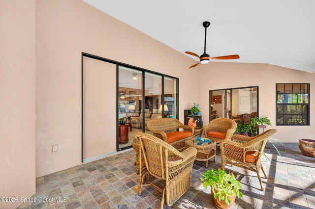 a dining room with furniture a chandelier and window