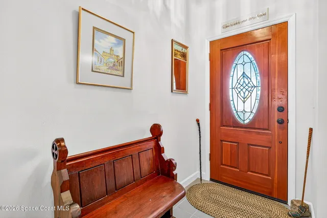 a view of front door with a door and a mirror