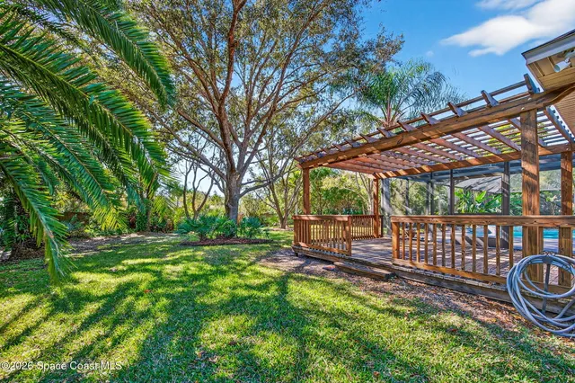 a view of a chair and table in the backyard