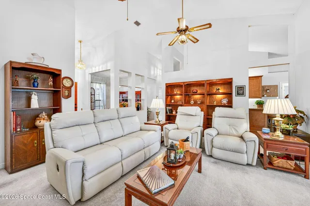 a living room with furniture gym equipment and a chandelier