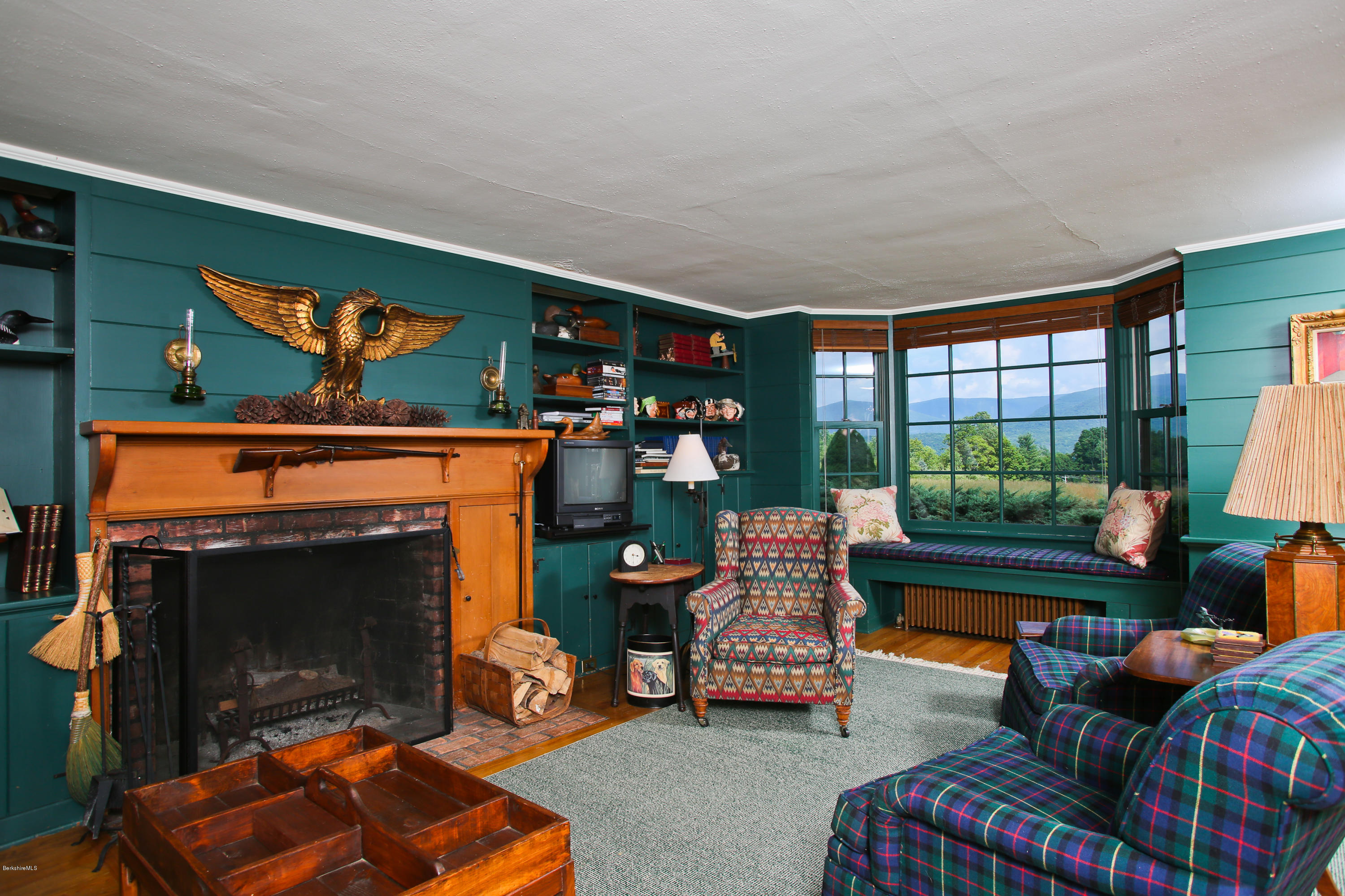 759 Hancock Road Williamstown, MA 01267 - Photo 20 of 71 a living room with furniture a fireplace and a flat screen tv