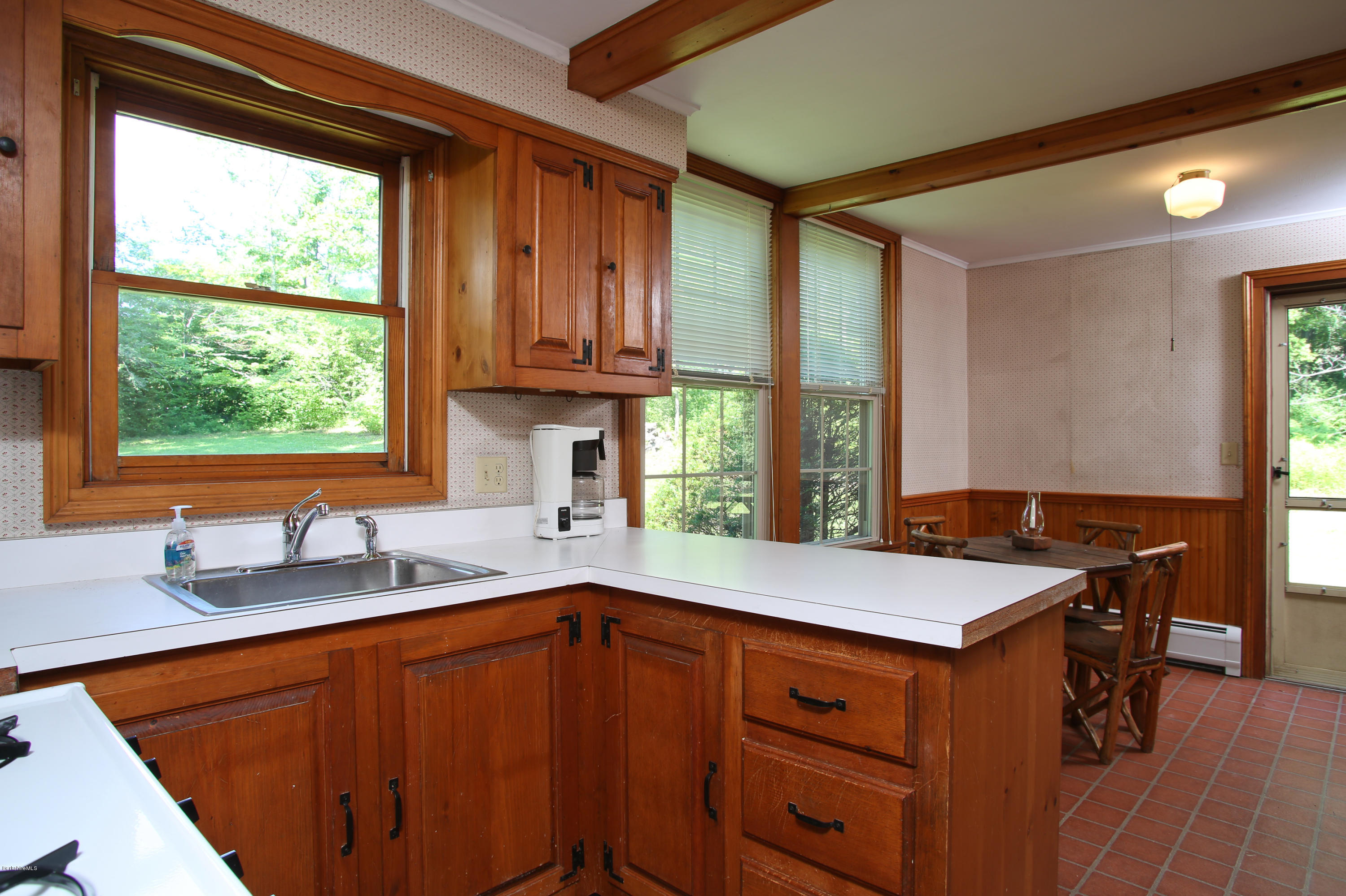 759 Hancock Road Williamstown, MA 01267 - Photo 60 of 71 a kitchen with a sink a window and chairs