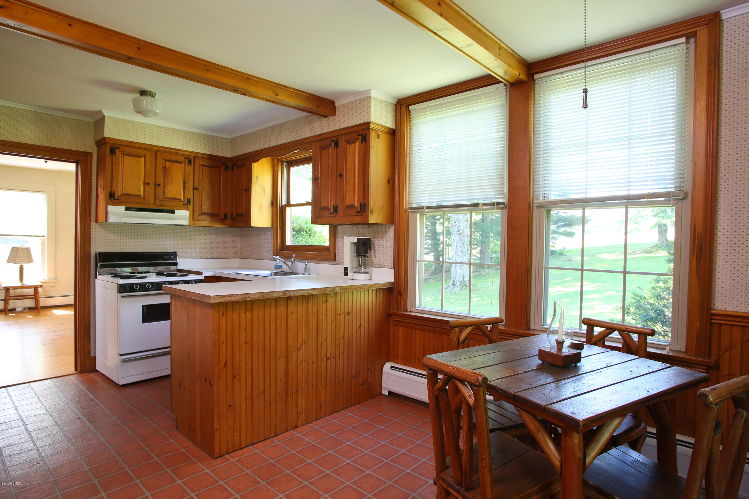 759 Hancock Road Williamstown, MA 01267 - Photo 61 of 71 a kitchen with stainless steel appliances granite countertop a stove a sink dishwasher and a refrigerator with wooden floor