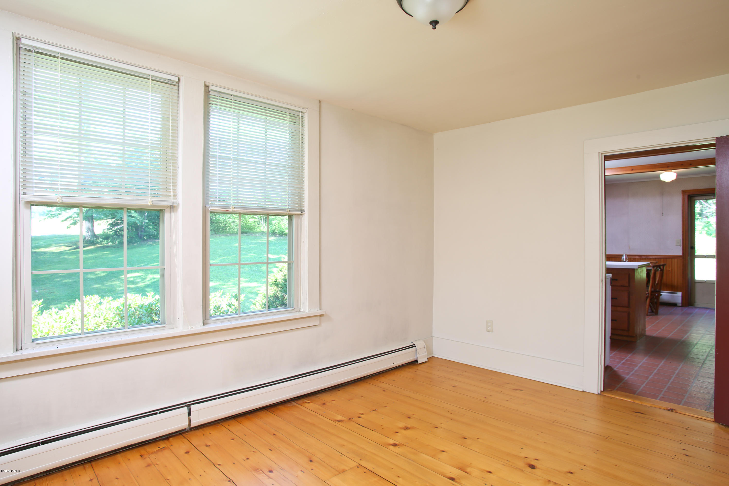 759 Hancock Road Williamstown, MA 01267 - Photo 62 of 71 a view of an empty room with wooden floor and a window